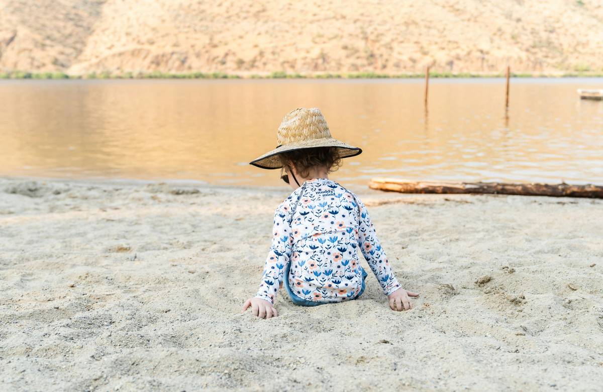 Non-nano zinc oxide baby sunscreen applied gently to infant cheek for sun protection baby sunscreen can i trust